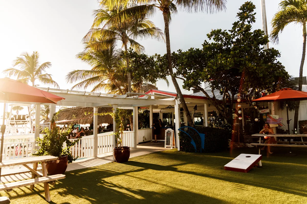 Covered Sundowners patio and palm-lined outdoor area